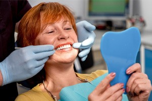 woman smiling in dental mirror 