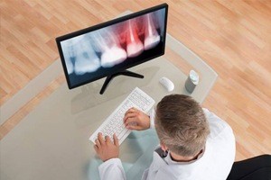 A dentist working on a computer