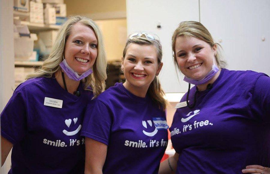 Three smiling team members