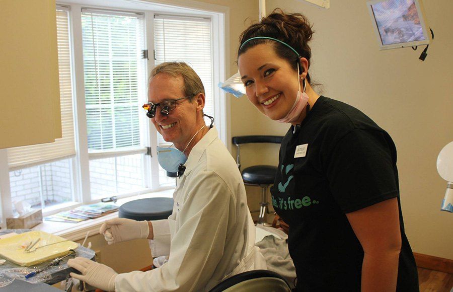 Smiling dentist and assistant