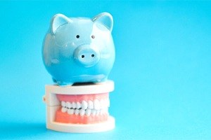 A piggy bank on top of a mouth mold