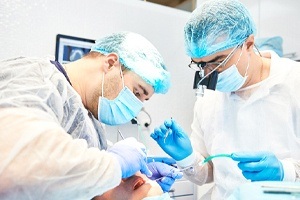 Dentists performing dental work on a patient