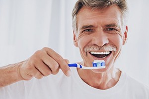 older man about to brush his teeth