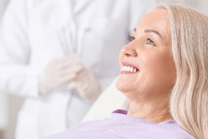 woman smiling while sitting in chair 