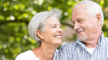 older couple smiling while looking at each other