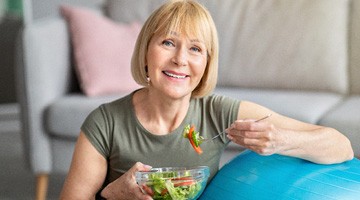 older woman eating salad