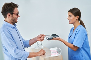 a man paying for dental care