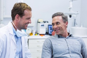 Springfield implant dentist talking with a seated male patient