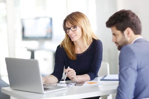 two people researching the cost of dental implants in Springfield