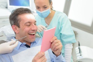 Man looking at smile in mirror