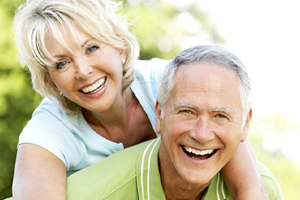 elderly couple holding each other 