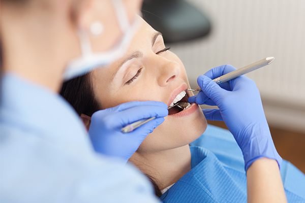 woman having teeth cleaned