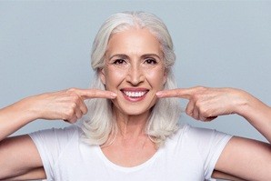 woman pointing to her teeth