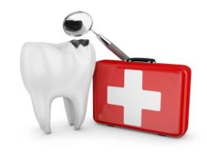 Model of a tooth next to a first-aid kit