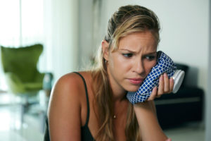 person suffering from tooth pain