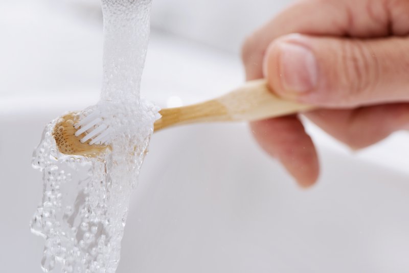 running water over toothbrush