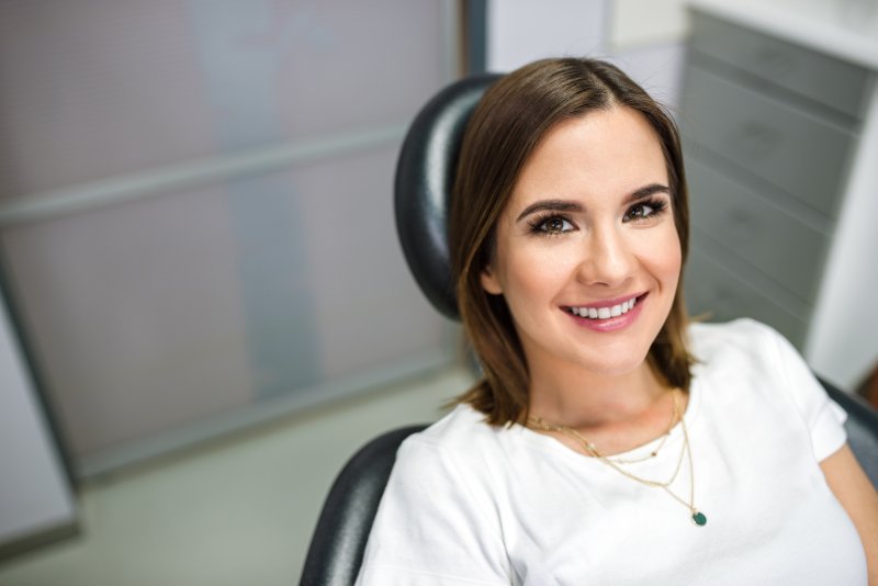 patient who had dental implant surgery smiling