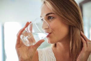 woman drinking a glass of water 