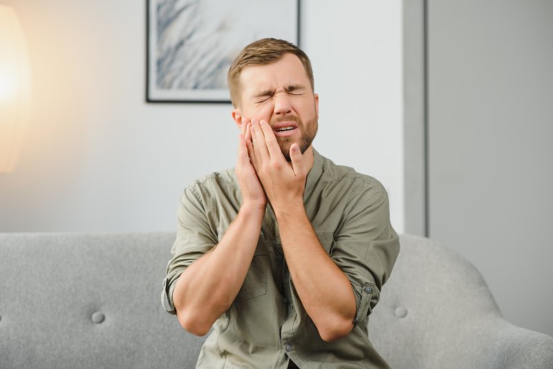 a man experiencing tooth sensitivity in Springfield