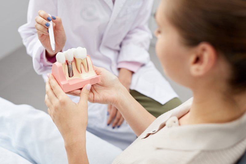 A dentist explaining dental implant lifespan in Springfield