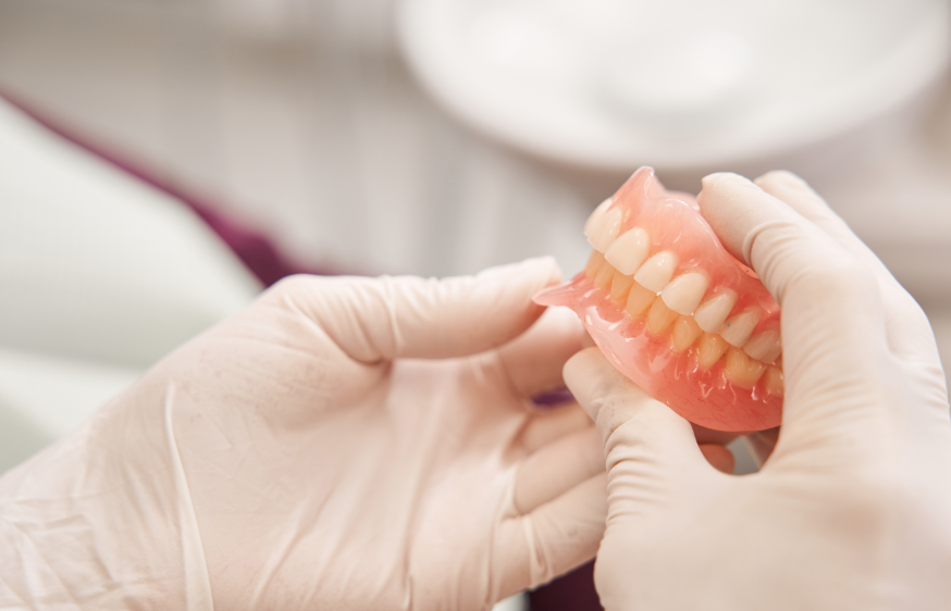 Dentist holding dentures